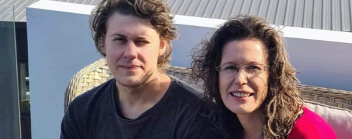 Isaac and his mother Juliana. Sitting together smiling after Isaac took a Davis Autism Approach Program