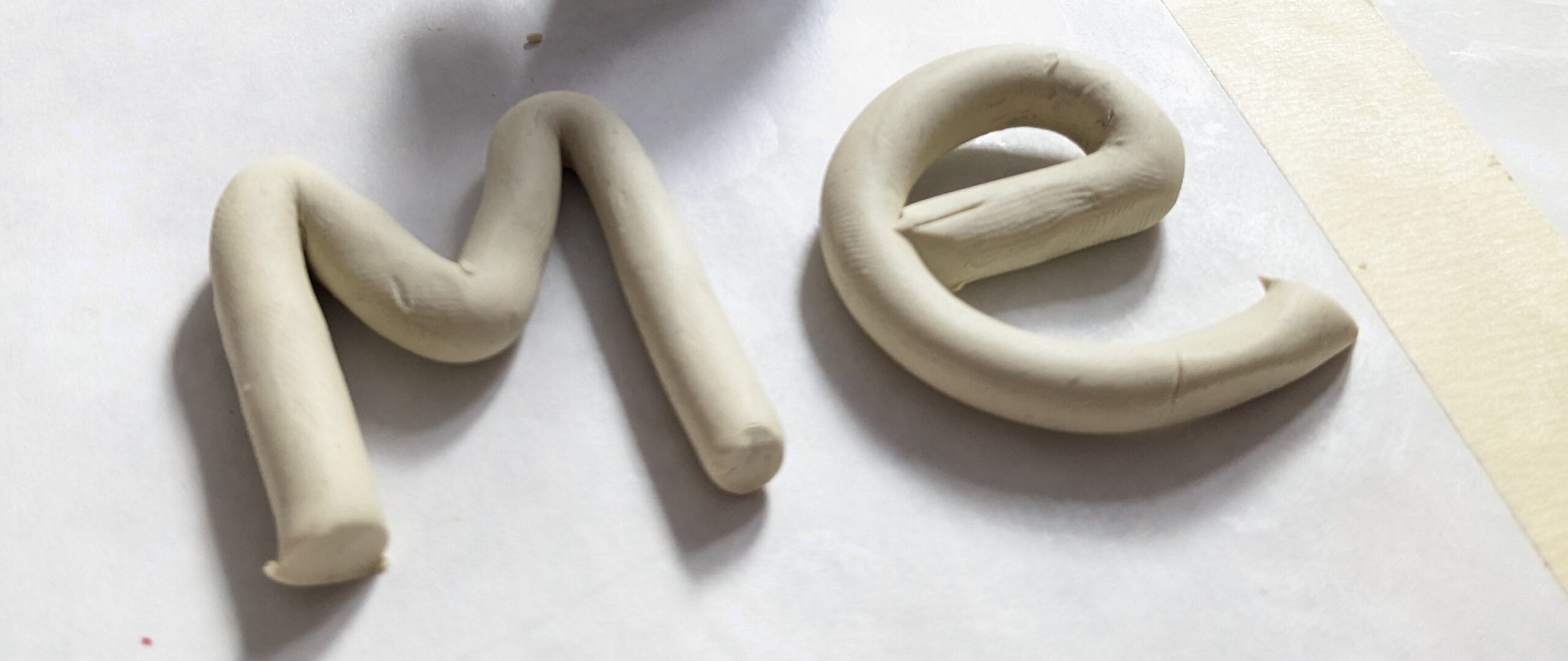 The word Me spelled in clay