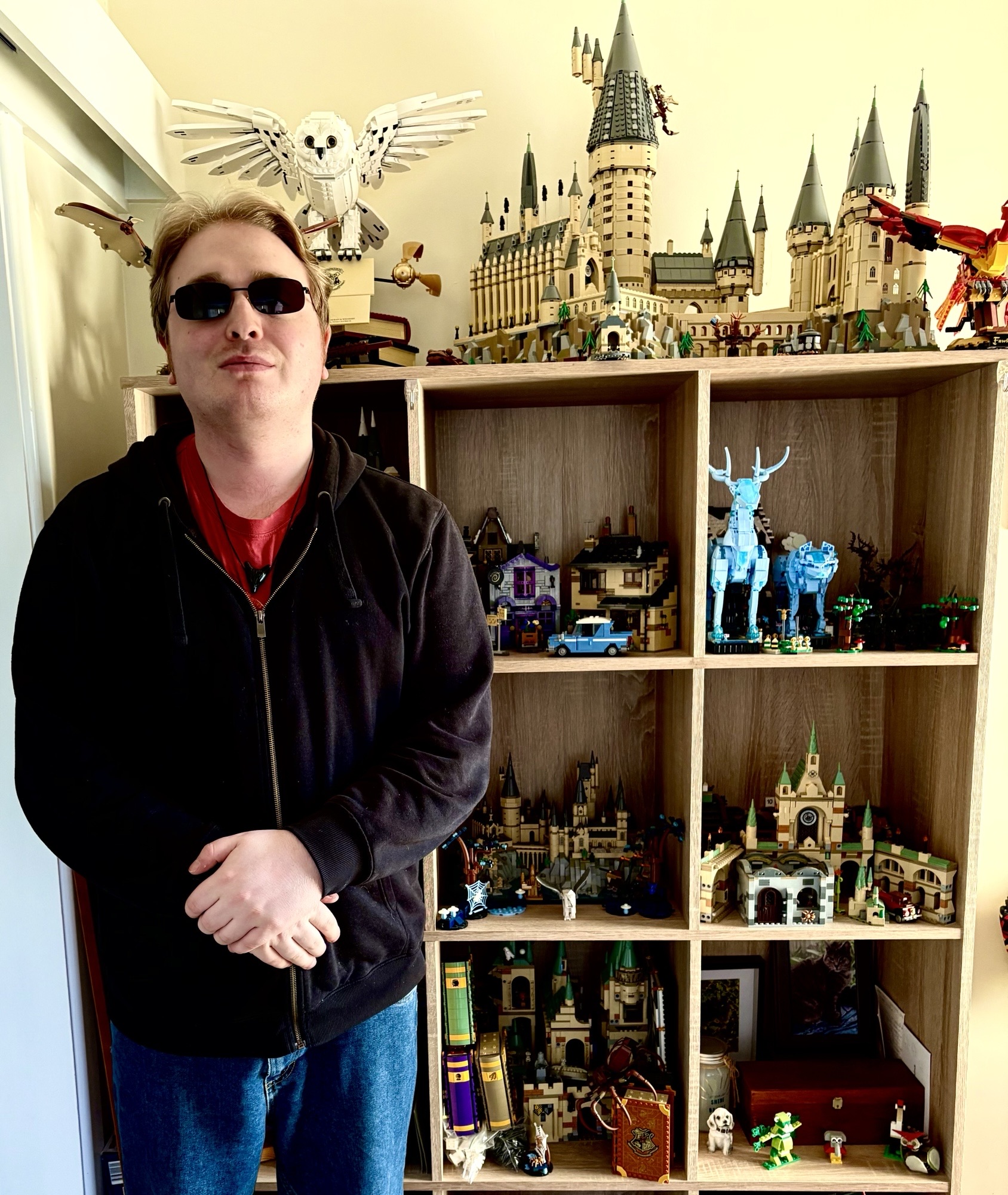 Sam standing in from of an impressive Lego collection